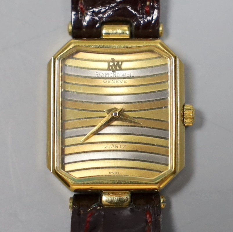 A lady's 18k gold electroplated Raymond Weil quartz wrist watch, with three colour dial, on a a leather strap, no box or papers.